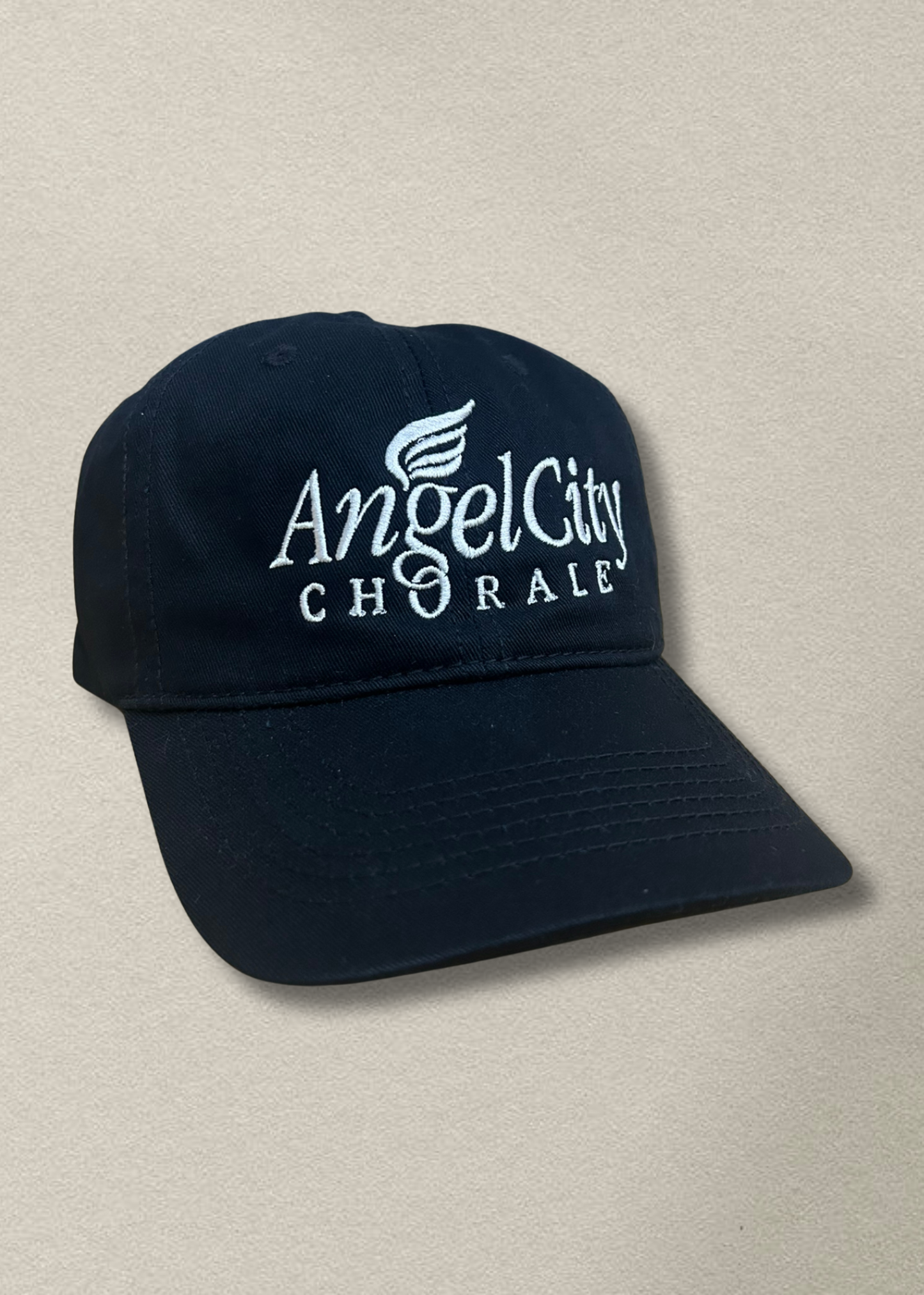 Black cap with 'Angel City Chorale' text on a beige background