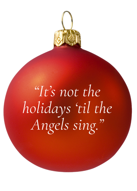 Red Christmas ornament with gold top and white text on a white background