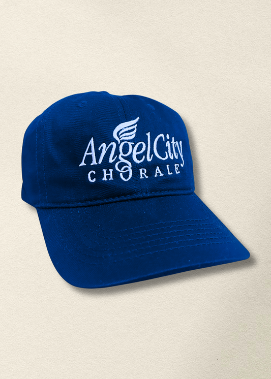 Blue cap with 'Angel City Chorale' logo on a beige background